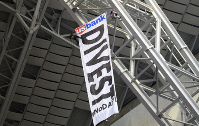 Pipeline protesters rappel from ceiling at Vikings stadium